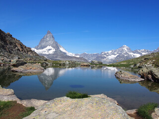 Matterhorn seen from the mountain climbed by the train in Zermatt on a sunny day.