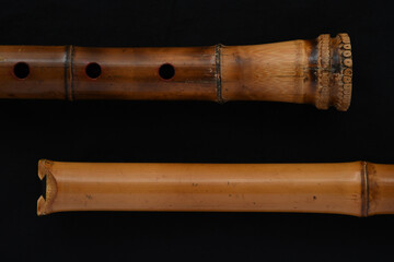 Shakuhachi flute, Shakuhachi is Japanese bamboo flute, on black background. © makoto photo