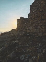 ruins at the top of the hill at sunset
