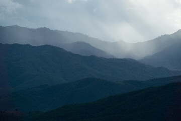 Landscape of Distant mountain range and layer in morning sun ray and white fog at the valleys, Chiang Mai in Thailand