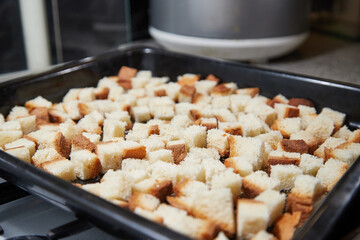 Square toasted pieces of homemade delicious rusk, hardtack, Dryasdust, zwieback on a baking sheet.