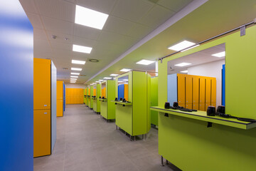 Interior of a indoor swimming pool changing and locker room with hair dryers