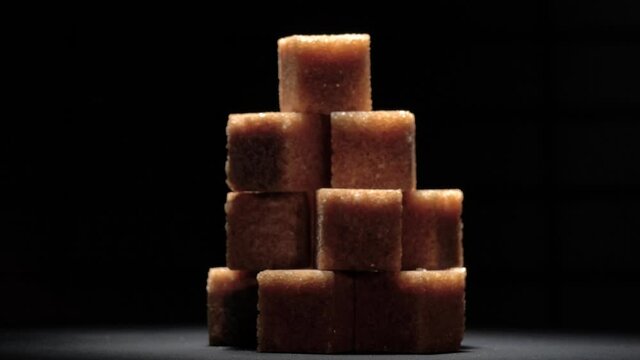 A piece of cane sugar like a pyramid on a blue background