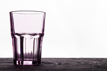 Faceted glass cup on a white background. Clean glassware container.