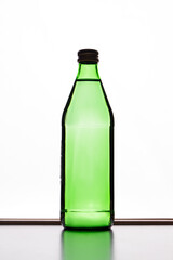 Green bottle isolated on the white background. Bottle with soft drink. Mineral water in a glass bottle.