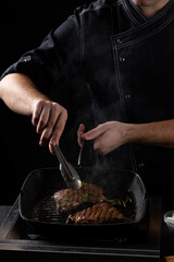 the chef prepares a beef steak in a pan