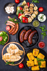 Grilled sausages, meat, and vegetables.