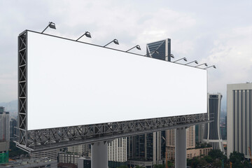 Blank white road billboard with KL cityscape background at day time. Street advertising poster, mock up, 3D rendering. Side view. The concept of marketing communication to promote or sell idea.