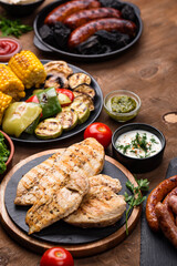 Grilled sausages, meat, and vegetables.