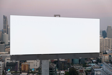 Fototapeta premium Blank white road billboard with Bangkok cityscape background at sunset. Street advertising poster, mock up, 3D rendering. Front view. The concept of marketing communication to promote or sell idea.