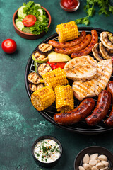 Grilled sausages, meat, and vegetables.