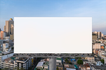 Blank white road billboard with Bangkok cityscape background at sunset. Street advertising poster, mock up, 3D rendering. Front view. The concept of marketing communication to promote or sell idea.