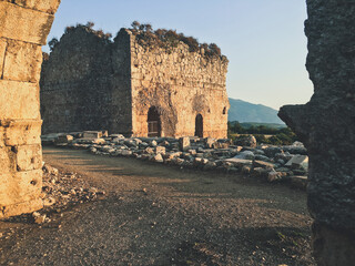 ruins of the castle at the top of the hill at sunset