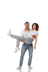 Fototapeta premium happy man holding in arms curly wife on white
