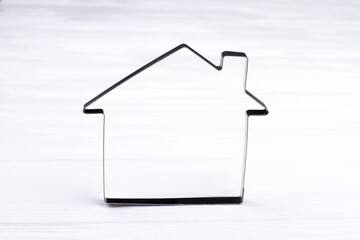 Metallic frame in a shape of house on white background. Outline home from top view. Home line icon.