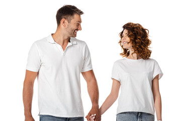 happy woman and cheerful man holding hands isolated on white