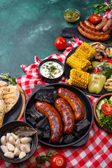 Grilled sausages, meat, and vegetables.