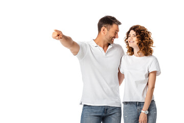 Fototapeta premium happy man pointing with finger while looking at cheerful woman isolated on white