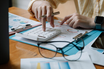 Accountant or banker calculate the financial report with calculator