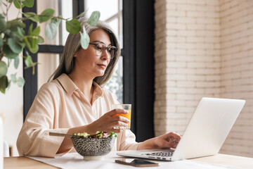 Concentrated business woman using laptop computer