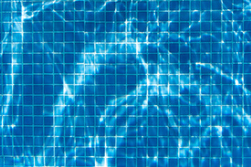 Swimming pool tiles. Pattern of the tiles of a pool with light reflections.