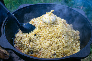 Uzbek pilaf in a cauldron close-up.