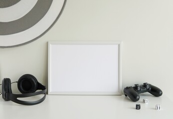 Horizontal white empty frame, game room frame mockup, monochrome gaming room interior, artwork display. © IndrePau