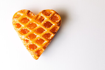 Heart shaped cookie with jam on a white background. heart-shaped cake on a white and bright background. Valentines Day