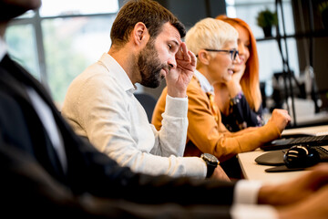 Young professional businessman under stress uses a computer for work in the office
