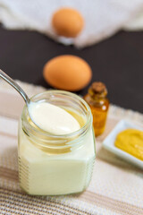 mayonnaise sauce and olive oil, eggs, mustard, lemon. Selective focus. vertical photo