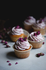 Cupcakes with raspberry cream and roses