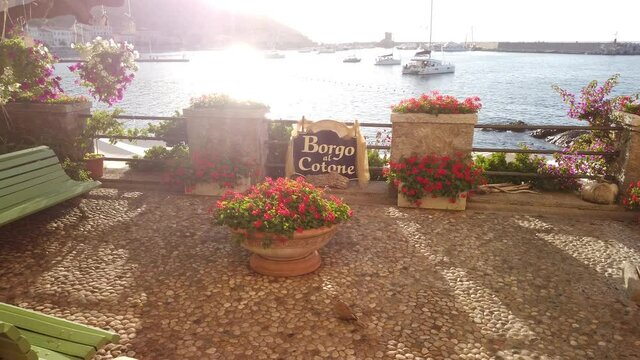 red geraniums and bougainvillea flowers, Marciana Marina at sunset, the flowery old district Borgo al Cotone: meaning COTTON VILLAGE. Holiday travel in Italy. Marciana Marina in summer on Elba island