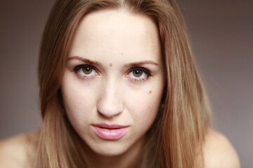 Fototapeta premium Emotional girl portrait on the brown background