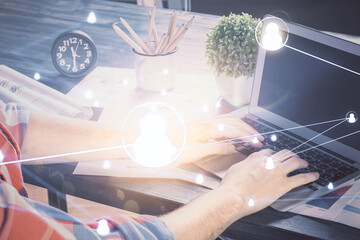 Media network theme hologram with man working on computer on background. Concept of internet...