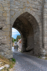 Fototapeta na wymiar Gates in Visby old town wall. Photo of medieval architecture. Gotland. Sweden