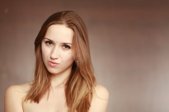 Emotional girl portrait on the brown background