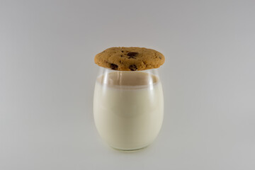 homemade cookie on buttermilk glass. White background.