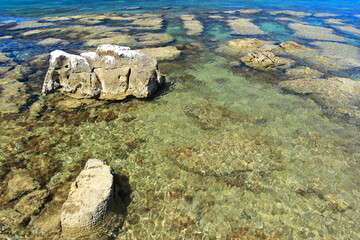 Clear blue sea on rocky beach near Rovinj, touristic destination in Croatia