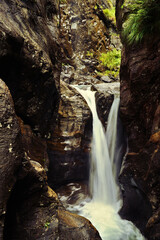 Fototapeta na wymiar Small waterfall from between rocks in Austria