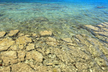 Clear blue sea on rocky beach near Rovinj, touristic destination in Croatia