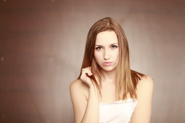 Emotional girl portrait on the brown background