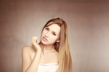 Fototapeta premium Emotional girl portrait on the brown background