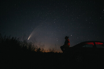 girl against starry sky and comet NEOWISE. Comet C / 2020 F3 NEOWISE Observation