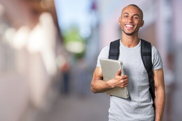 Smiling young black college student with laptop