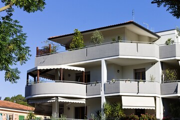 Obraz premium A house with large balconies and ornamental plants (Pesaro, Italy, Europe)