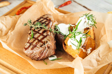 New york beef steak baked potatoes  sour cream 