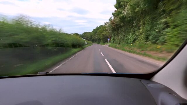 From driver's perspective, an electric car going fast along a windy open 'A' road on the left hand side of the road.
