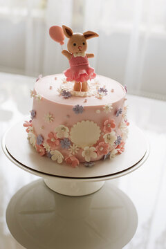 Vertical photo of pink cake birthday girl with figure , figure flowers and cat