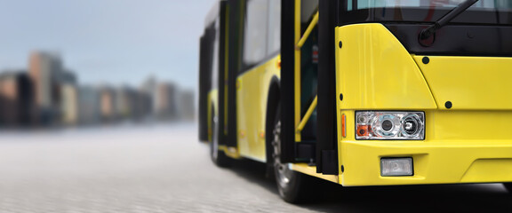 Yellow city bus on downtown background - obrazy, fototapety, plakaty