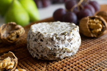 Premium organic goat cheese  on a rustic wooden cheese maker.